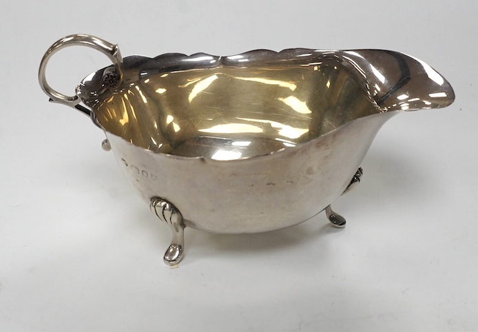 Two George V silver sauceboats and two cased flatware sets. Condition - fair
